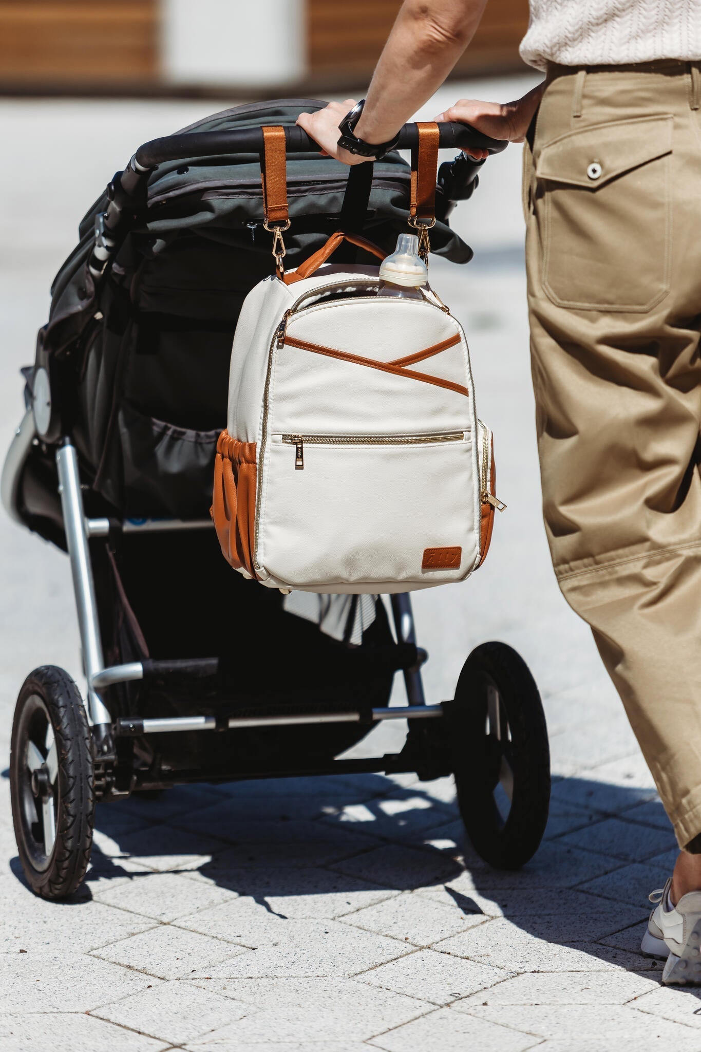 Stylish unisex backpack on stroller, available on USMIH Grid, buy with card or cryptocurrency, featuring European brands.