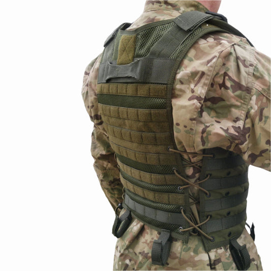 Tactical vest 115-056-03 in military green with MOLLE system straps and USMIH Grid, shown from the back on camouflaged uniform.