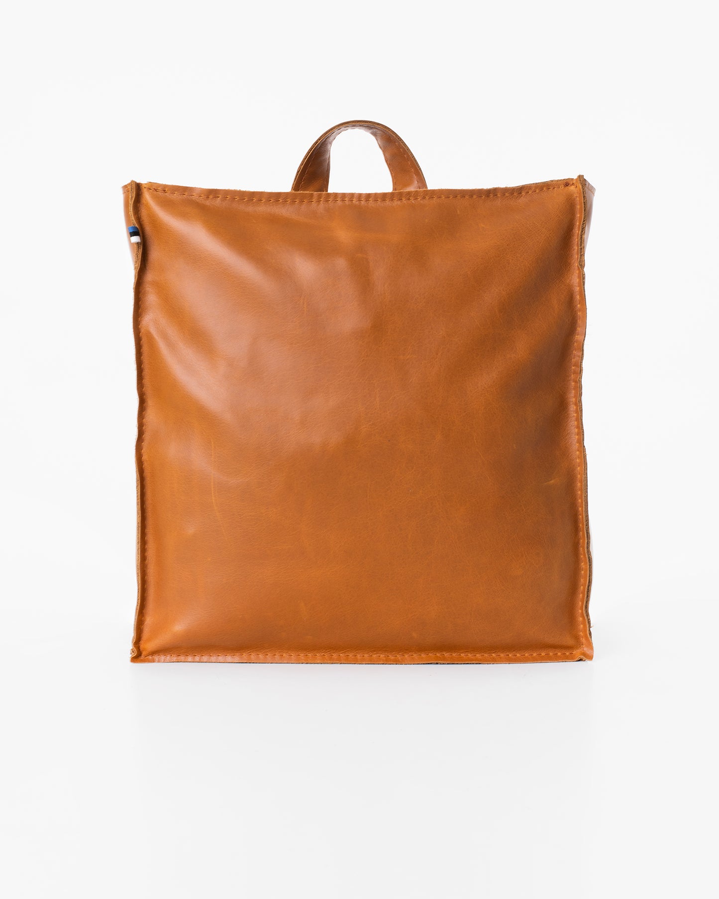 Folk 2 Leather Backpack in Caramel - Handmade from high-quality furniture manufacturing leftovers with unique design.