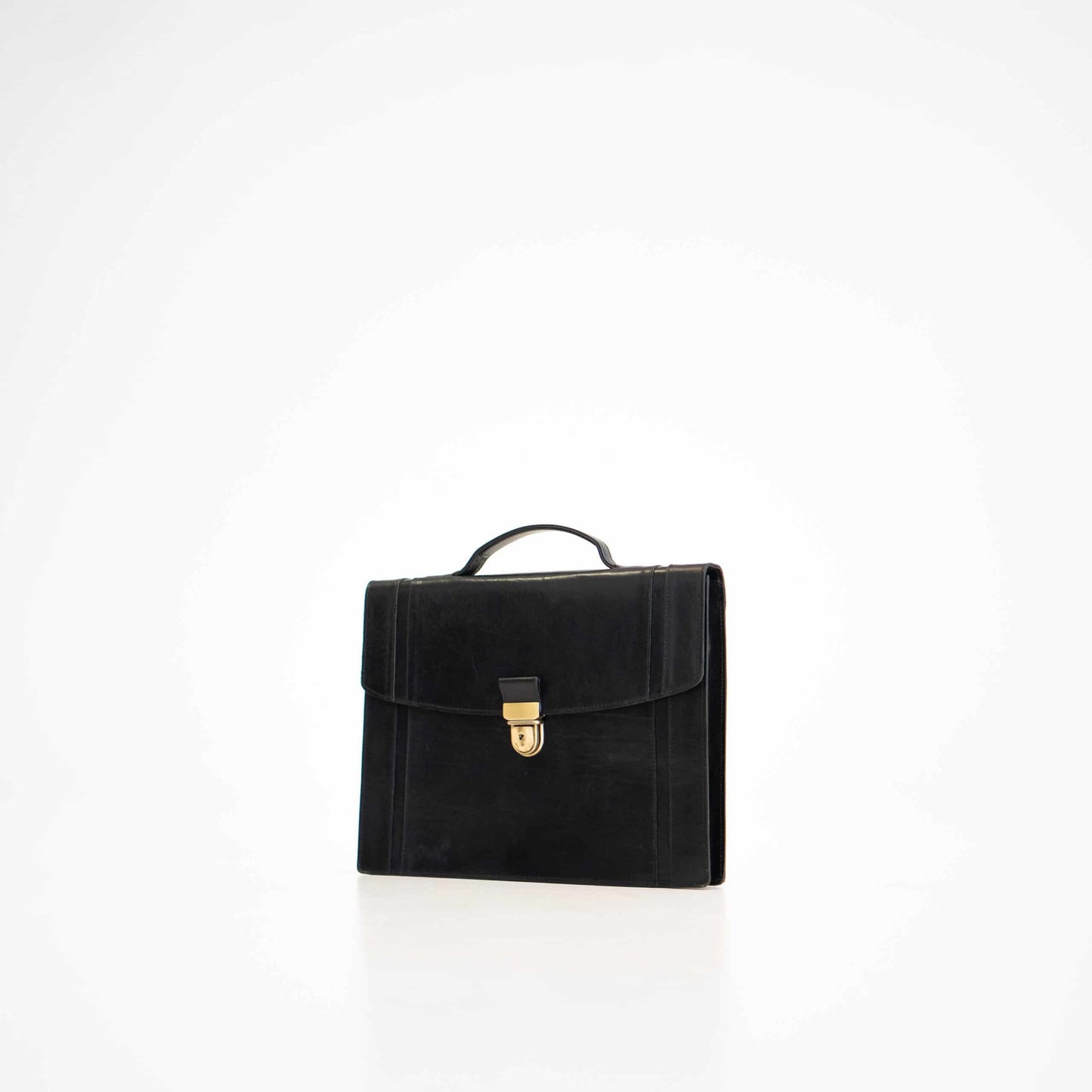 Black leather briefcase No. 21 with gold clasp, featuring elegant minimalistic design by Estonian craftsmen.