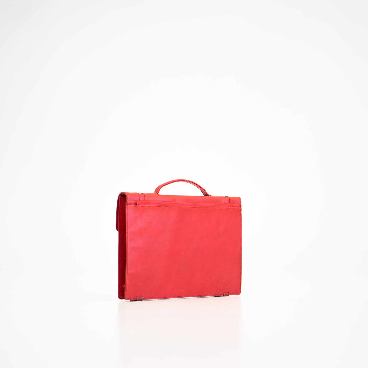 Red leather Briefcase No. 21, showcasing minimalist design with spacious main compartment and A4 zip pocket, crafted in Estonia.