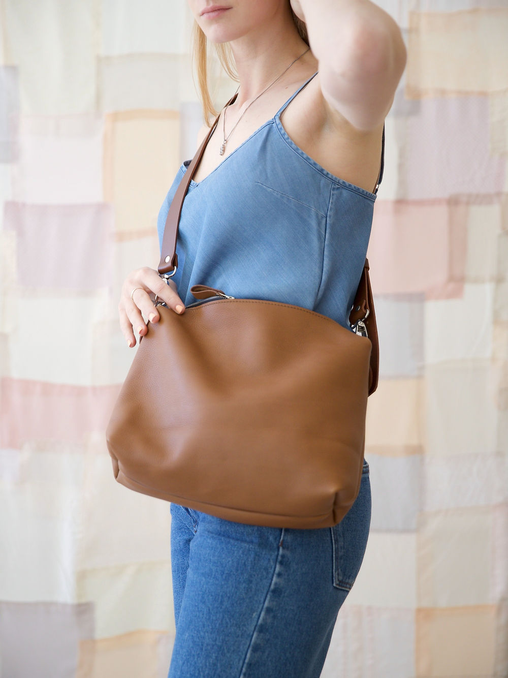 Woman wearing ROBIN Leather Handbag Large in Camel Brown from USMIH Grid, available for card and Bitcoin payments.