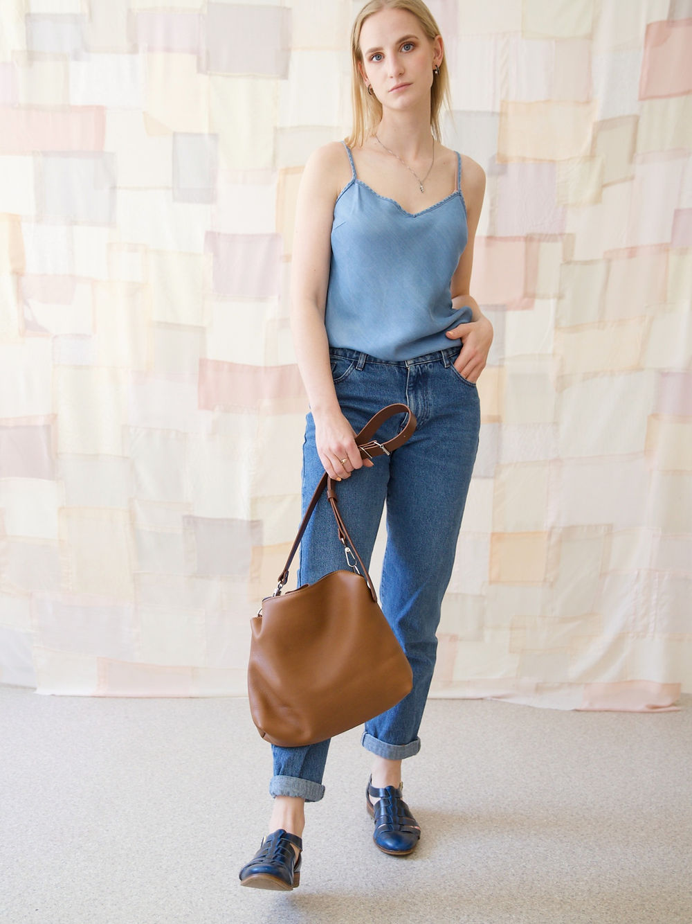 "Model with ROBIN Leather Handbag in Camel Brown, available on USMIH Grid for card and cryptocurrency payments, showcasing European style."