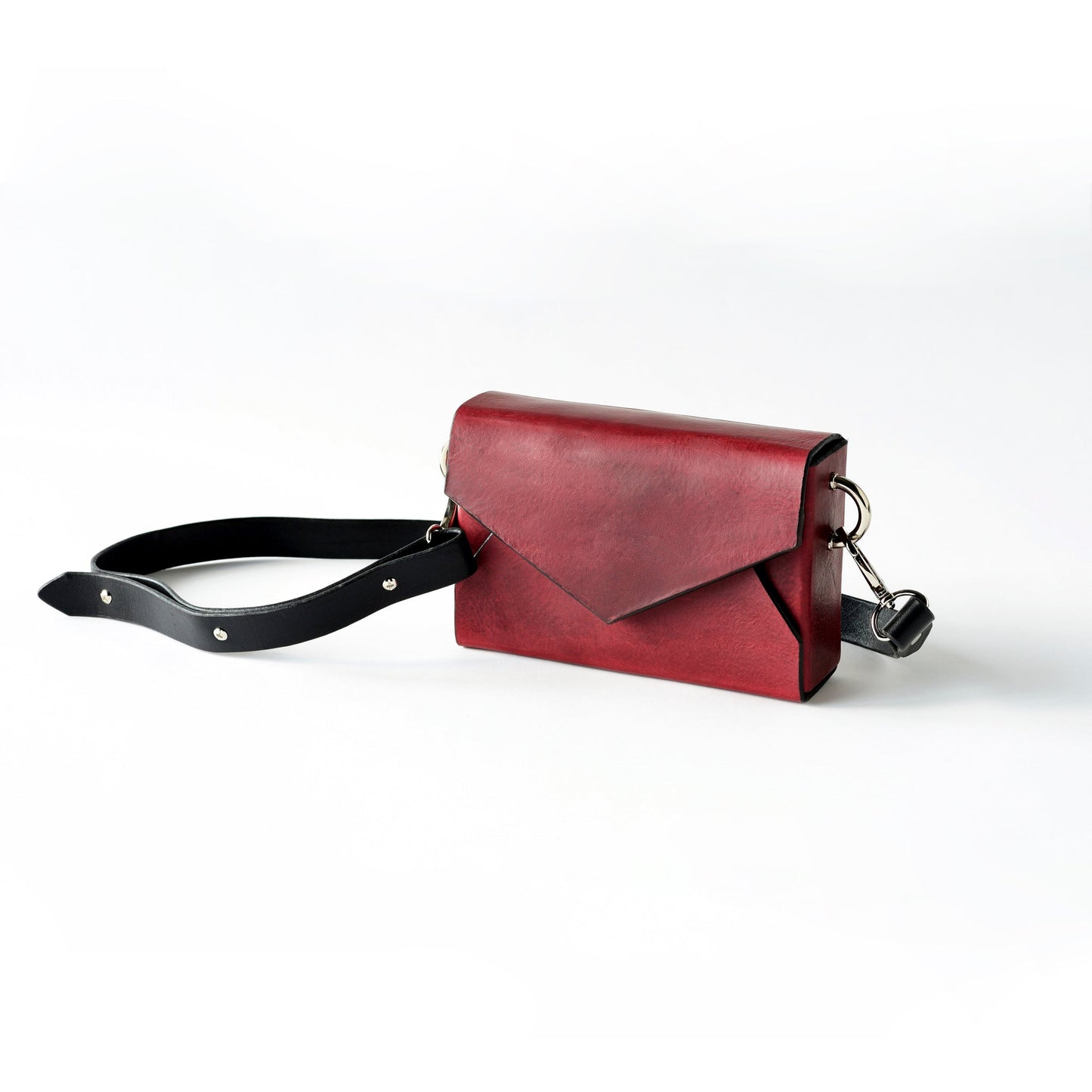 Handmade burgundy leather envelope bag with adjustable strap, available on USMIH Grid. Pay with card, Bitcoin, or altcoin. Modern European style.