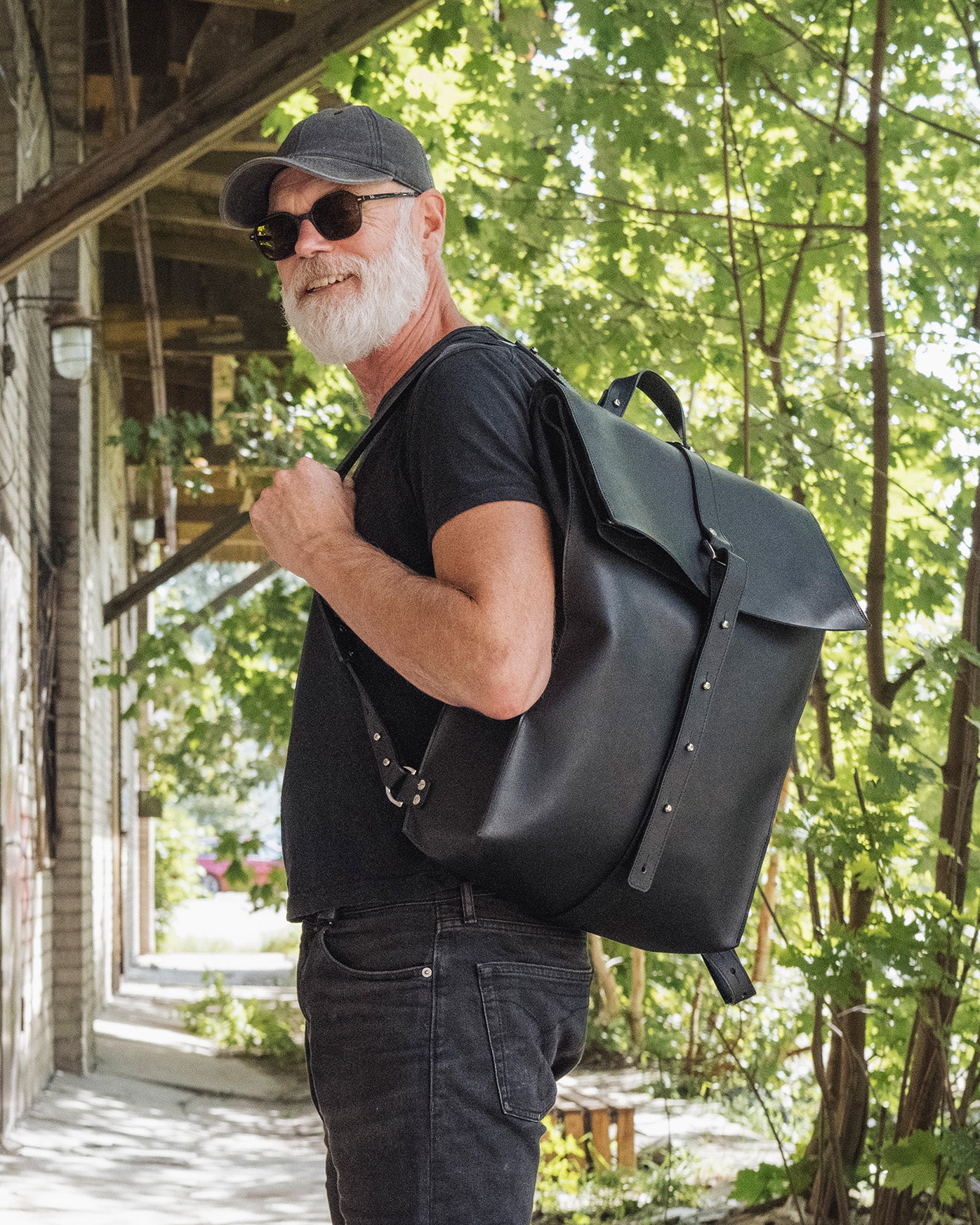 Stylish man wearing Stella Soomlais x Gary Markle Go To Helsinki Knapsack, ideal for travelers and commuters, available at USMIH.