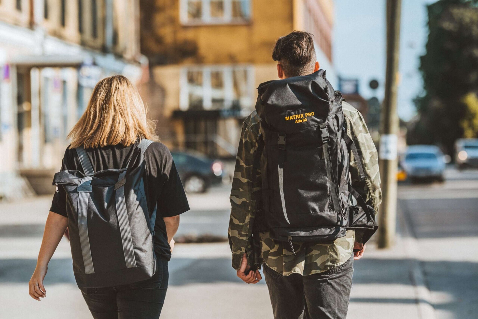 Two people walking in a city with Matrix Pro Alfa 30 hiking bags, showcasing versatility for everyday use and outdoor adventures - avalable in USMIH Grid online store marketplace for premium European brands