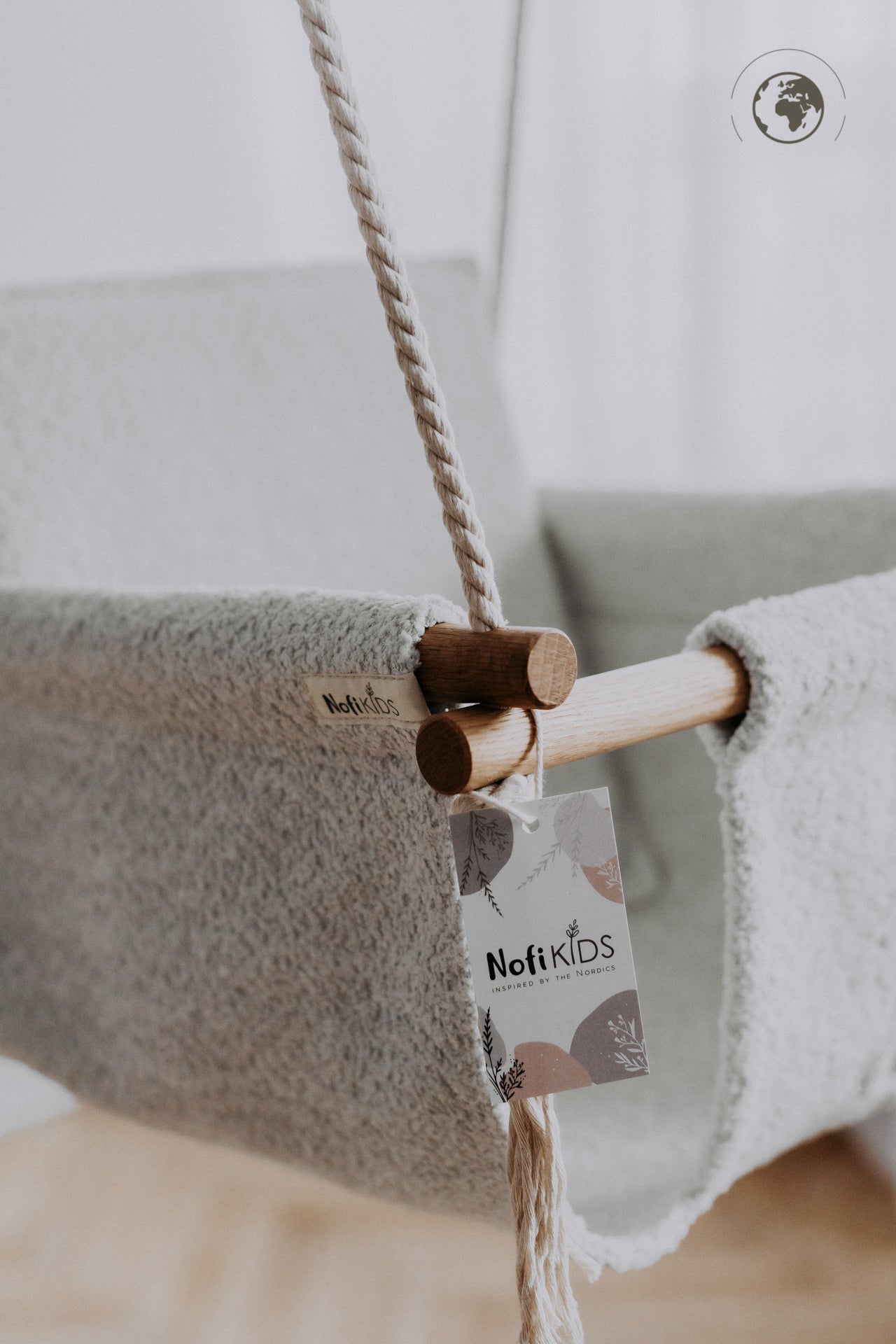 BaBi Baby Swing in Bouclé Ice Grey with oak wood poles, eco-friendly design, USMIH Grid approved, showcasing label detail.