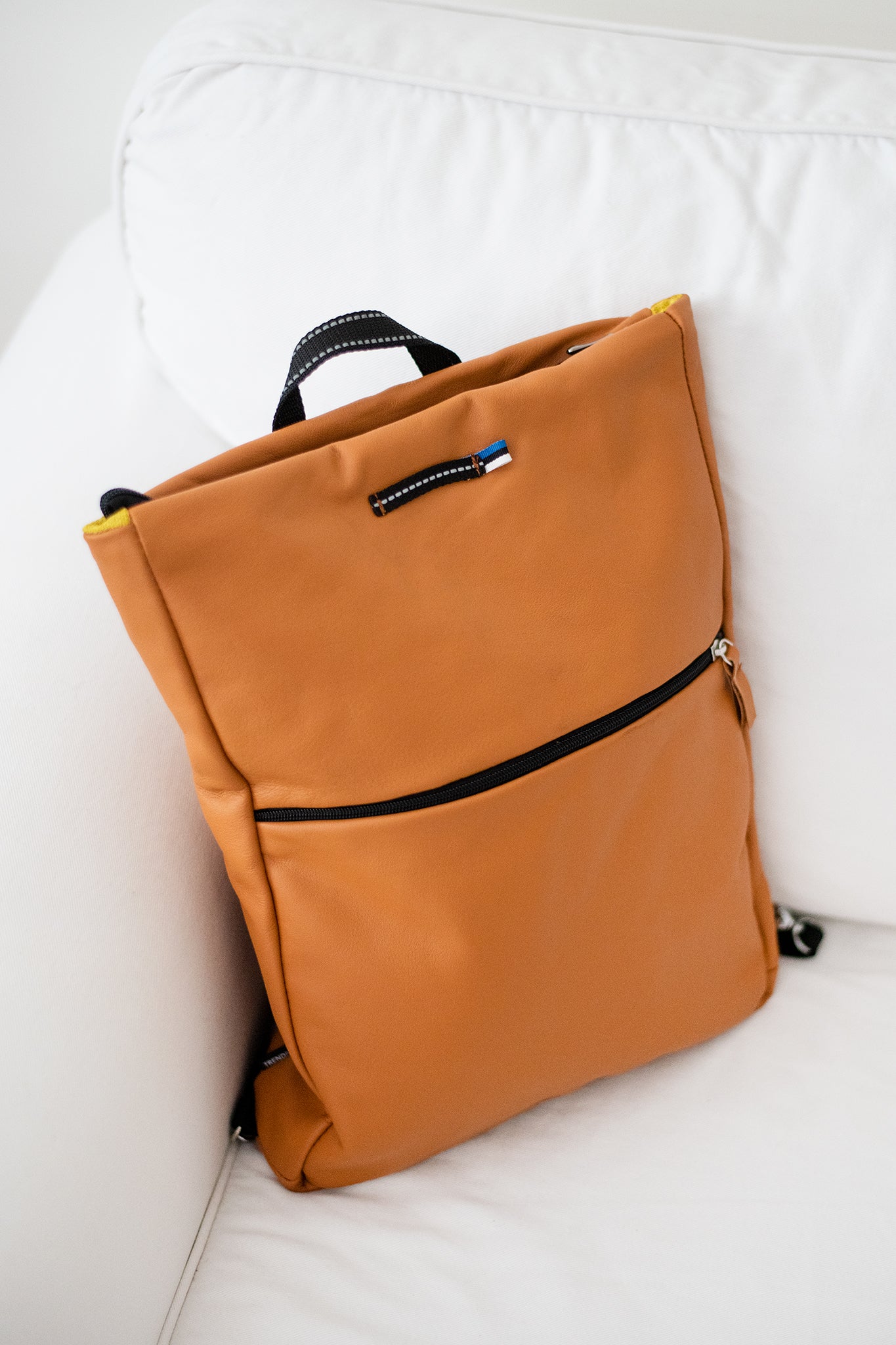 Handmade Barbara Leather Backpack in Calvados color with large compartment, zippered pocket, and laptop compartment, made from furniture leftovers.