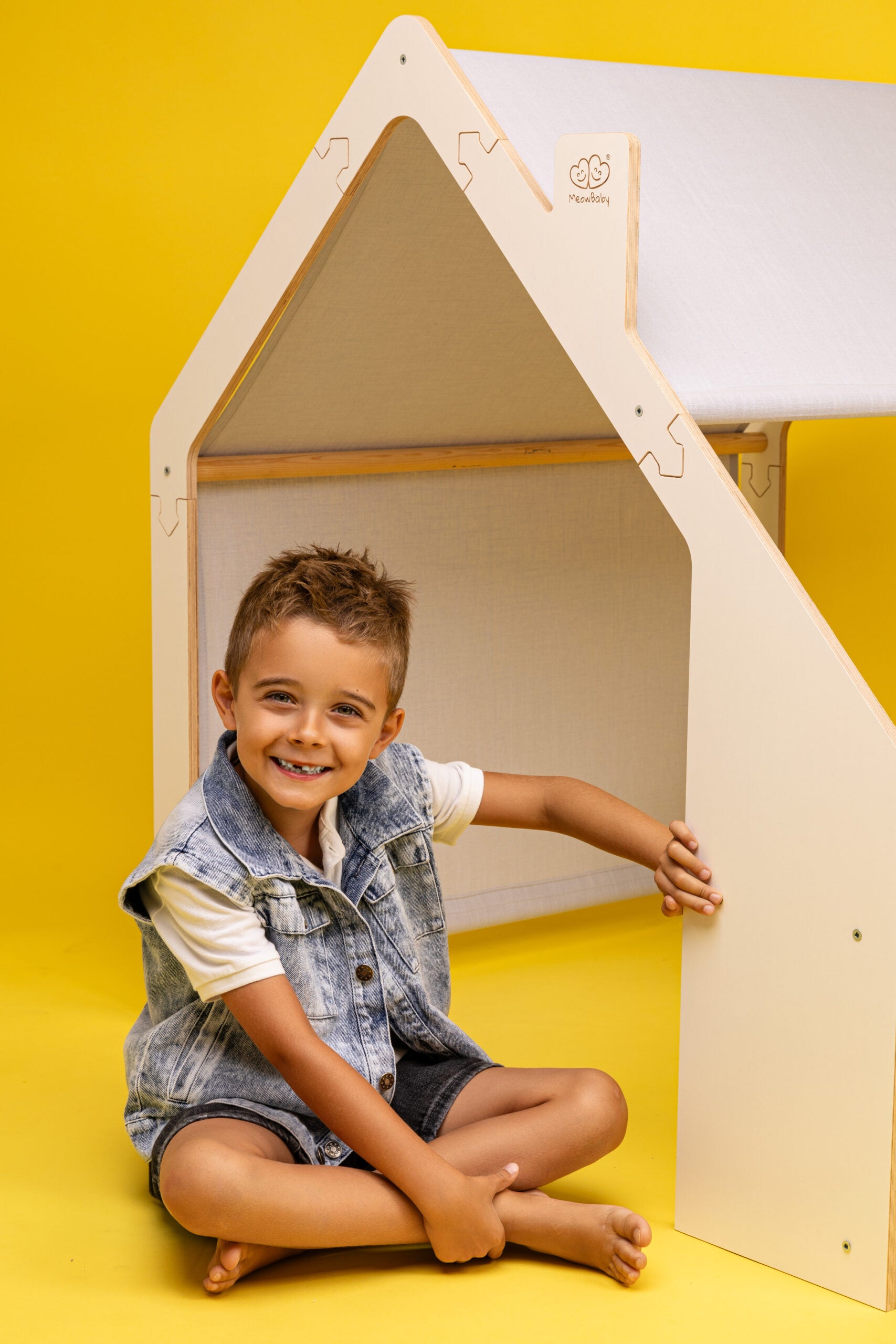 Child smiling next to the MeowBaby® White Wooden House with Blue Roof, ideal luxury gift for imaginative play | Find USMIH.