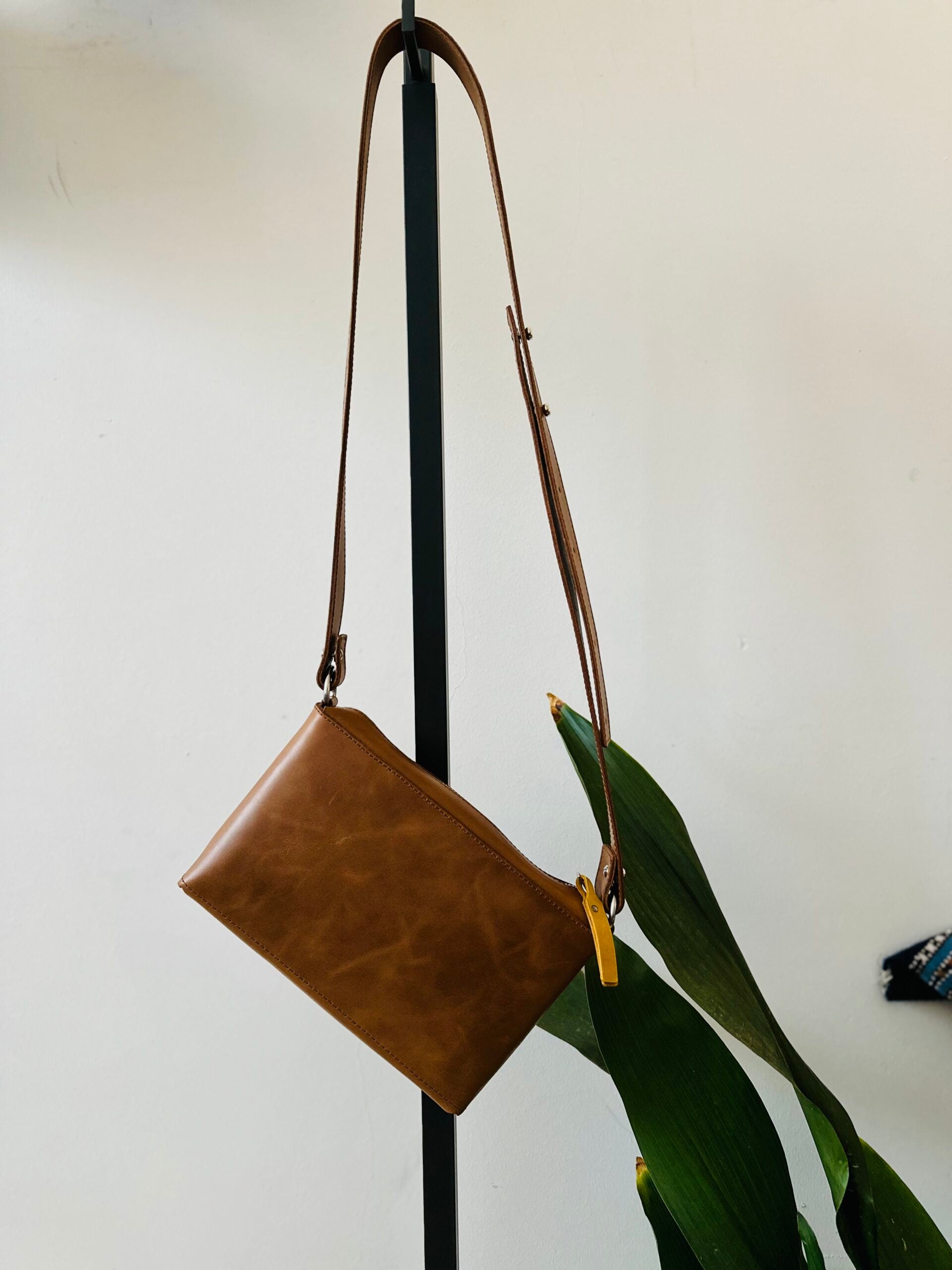 Crossbody leather bag with adjustable strap, perfect for adventurers. Available in USMIH Grid, purchase with card or crypto. USMIH Grid | Join the Grid!