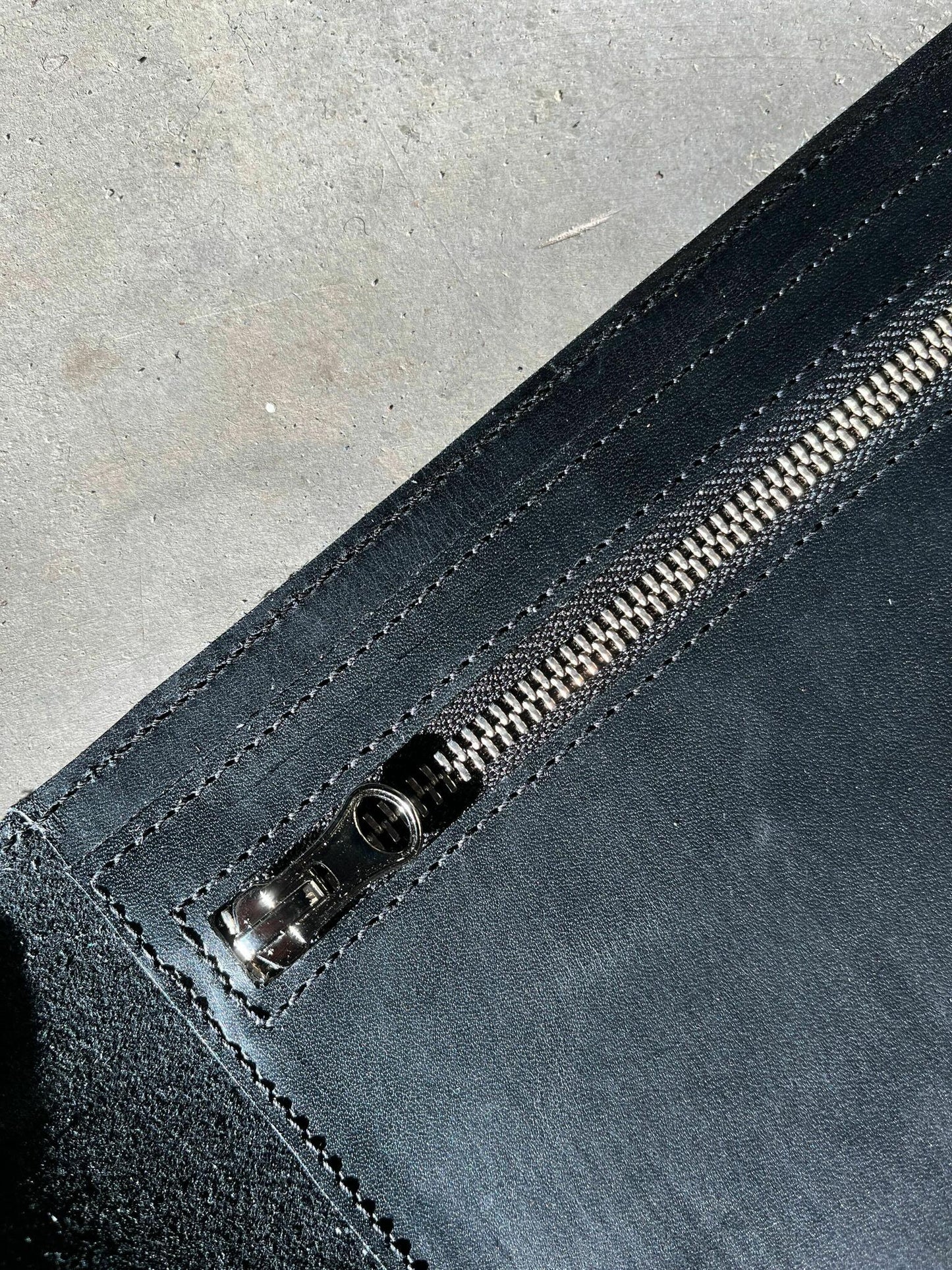 Close-up of the zipper pocket on the Undercover Lover Handbag, a high-quality leather bag available for purchase on USMIH Grid.