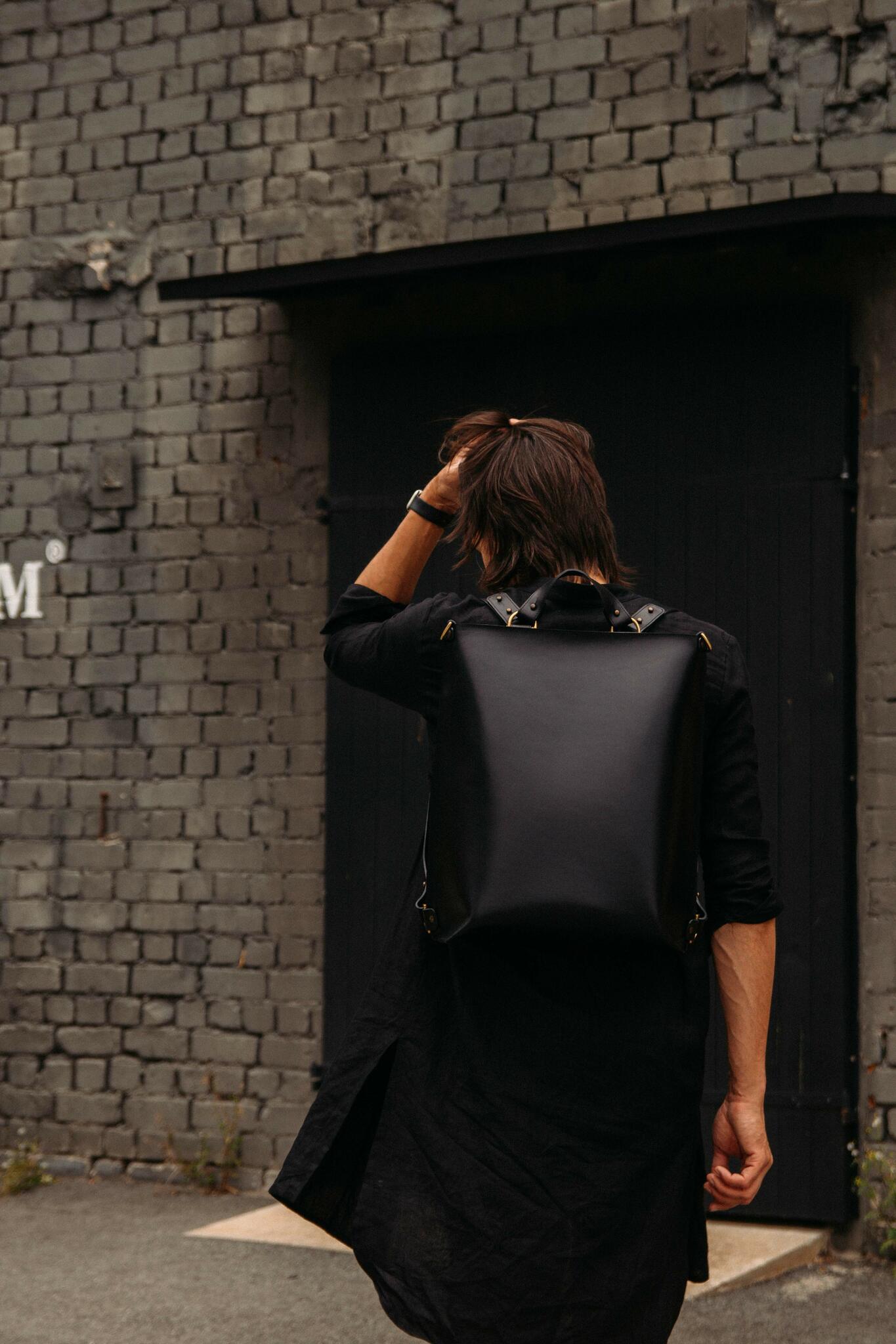 Stylish leather backpack worn by person, showcasing high-quality design. Available online at USMIH Grid with crypto payments.