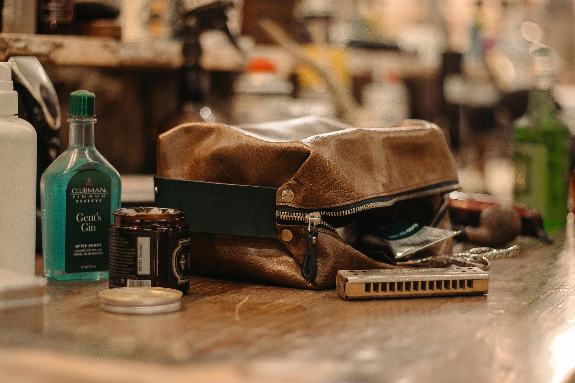 Leather toiletry bag on counter with grooming essentials, available on USMIH Grid - a modern European marketplace for luxury accessories.