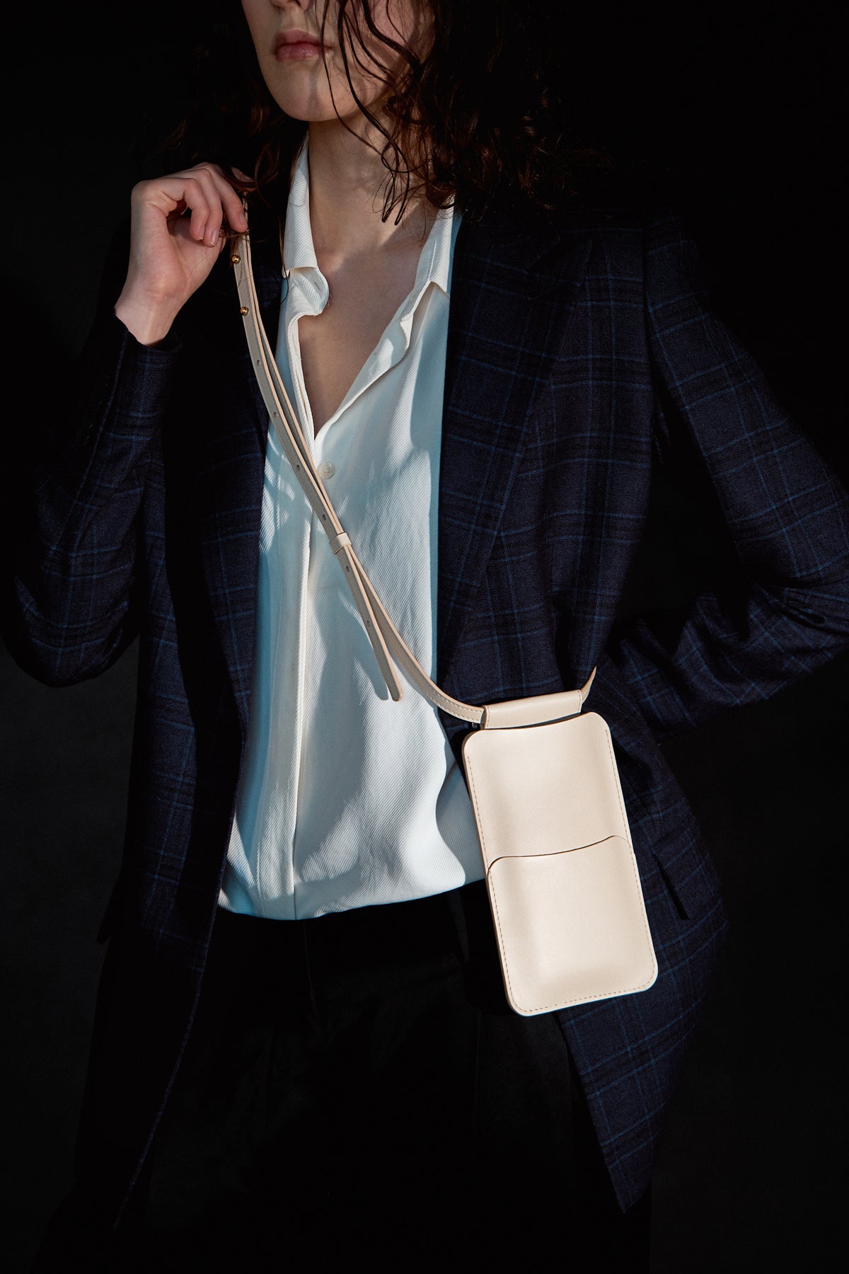 Beige leather phone bag with adjustable strap, available on USMIH Grid. Perfect for carrying phone and cards, purchase with card or cryptocurrency.