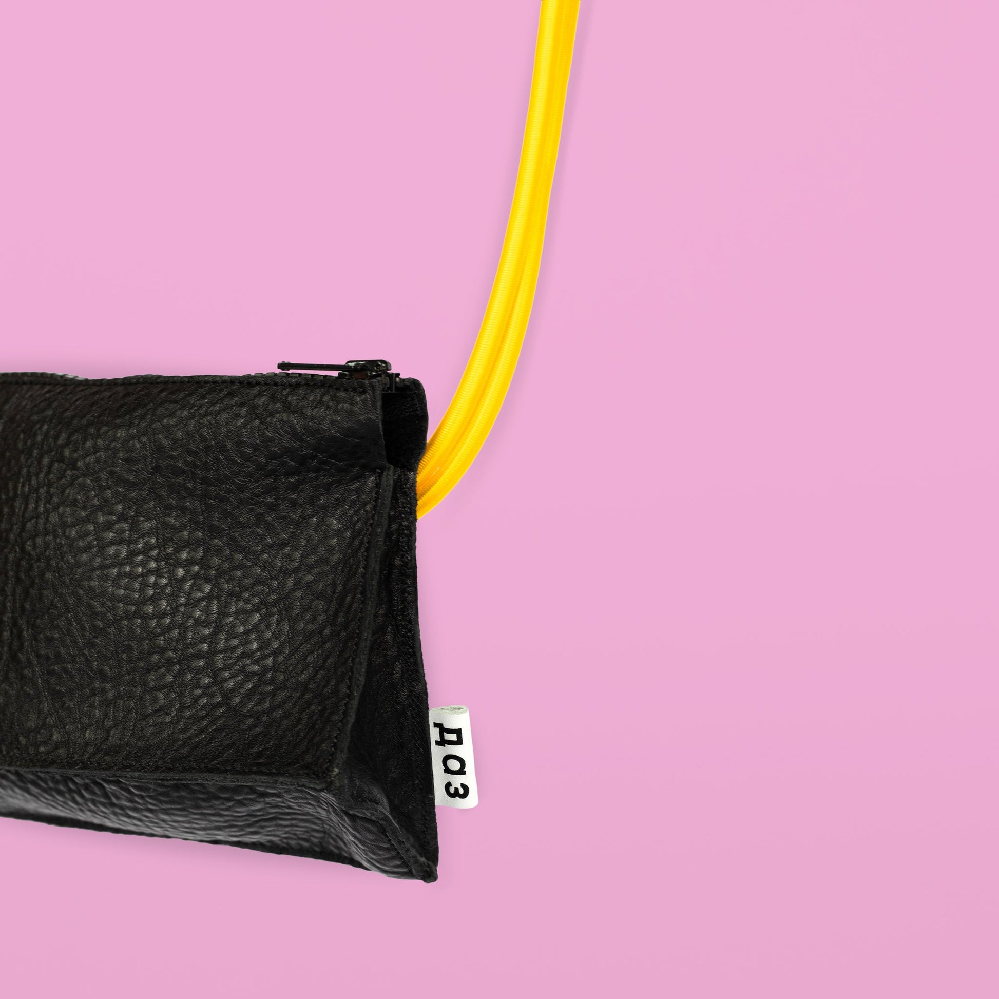 Handmade black leather bum bag with yellow strap, available on USMIH Grid. Purchase with card or cryptocurrency. European brand.