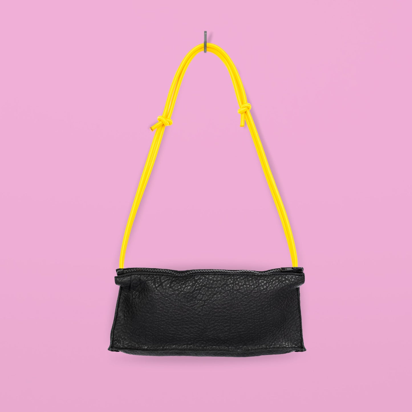 Handmade black leather bum bag with yellow strap on pink background, available on USMIH Grid, supports card and Bitcoin payments.