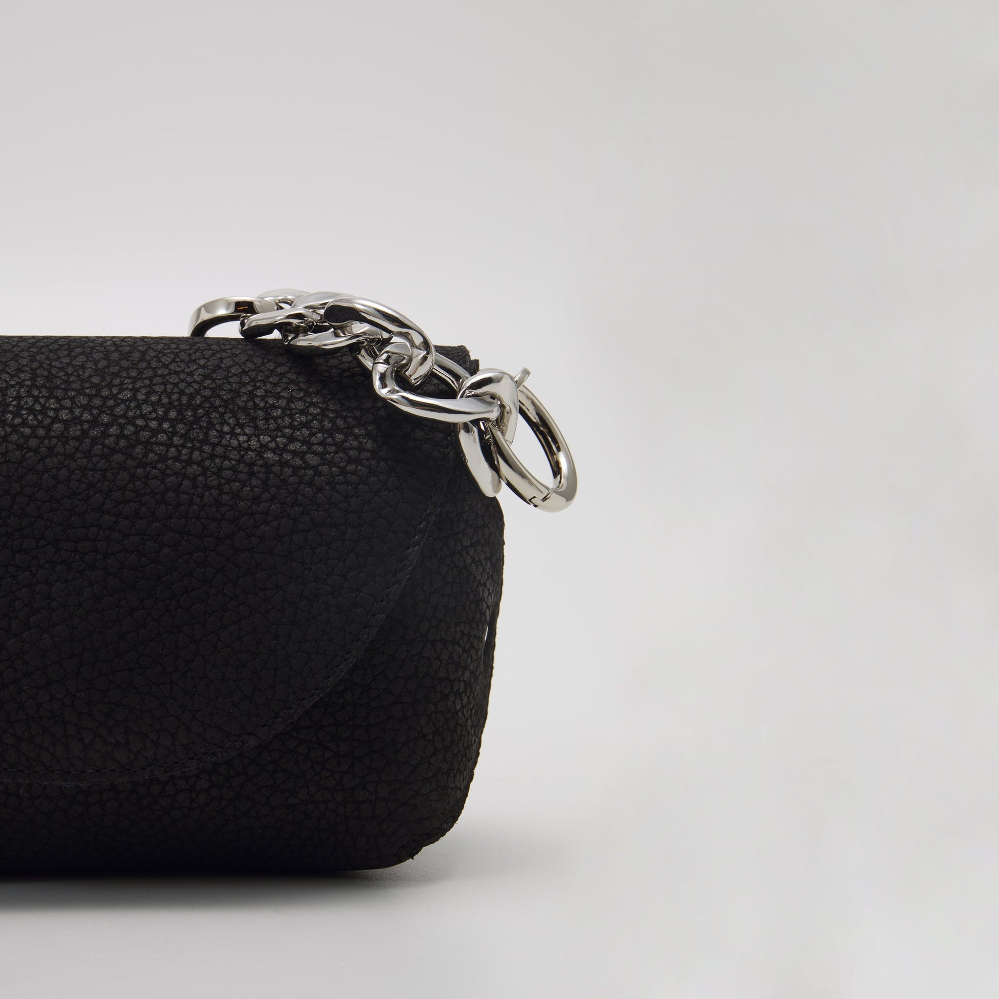 Close-up of black handmade leather shoulder bag with silver hardware, available on USMIH Grid, buy with card or cryptocurrency.