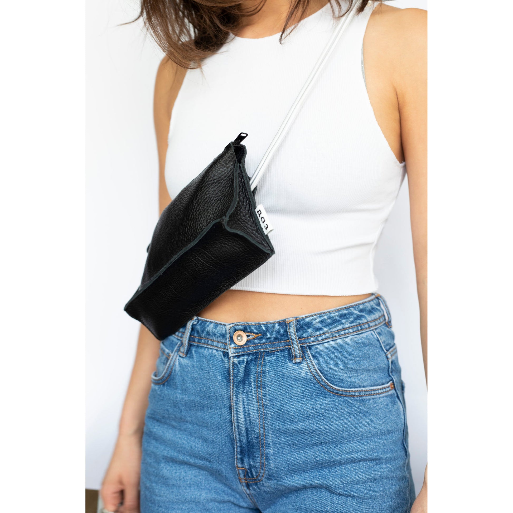 Woman wearing a Handmade Leather Bum Bag in black and white with adjustable strap, available on USMIH Grid. Buy with card or cryptocurrency.