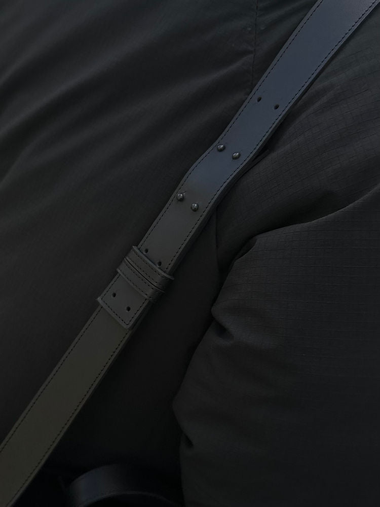 Close-up of a black leather strap on a BOX Bag, showcasing durability and elegant design.