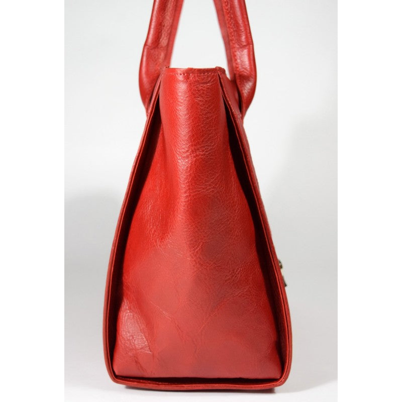 Side view of Estonian-crafted cognac Papillon leather handbag with a reinforced base and protective knobs