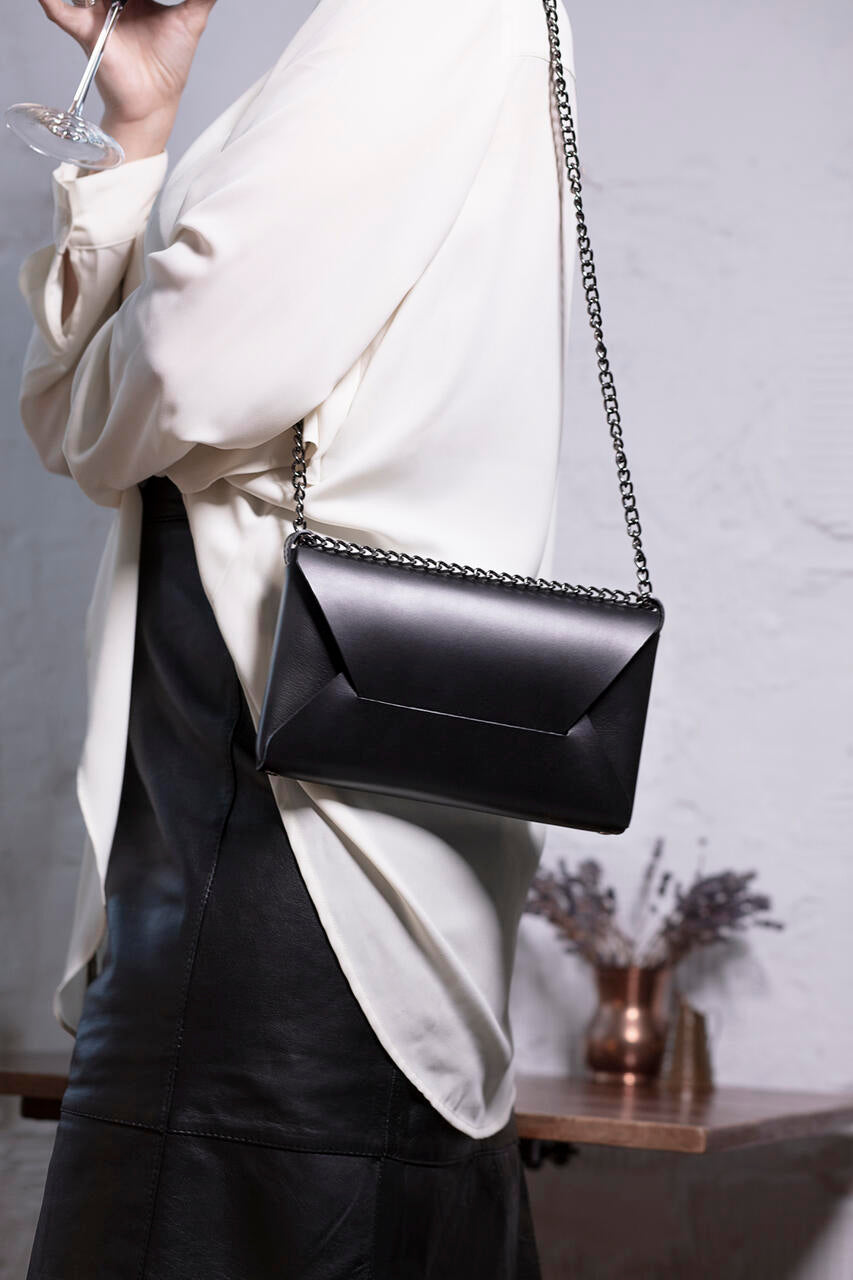 Luxurious black leather Wine & Dine evening bag from Stella Soomlais, available on USMIH Grid; pay with card or crypto.