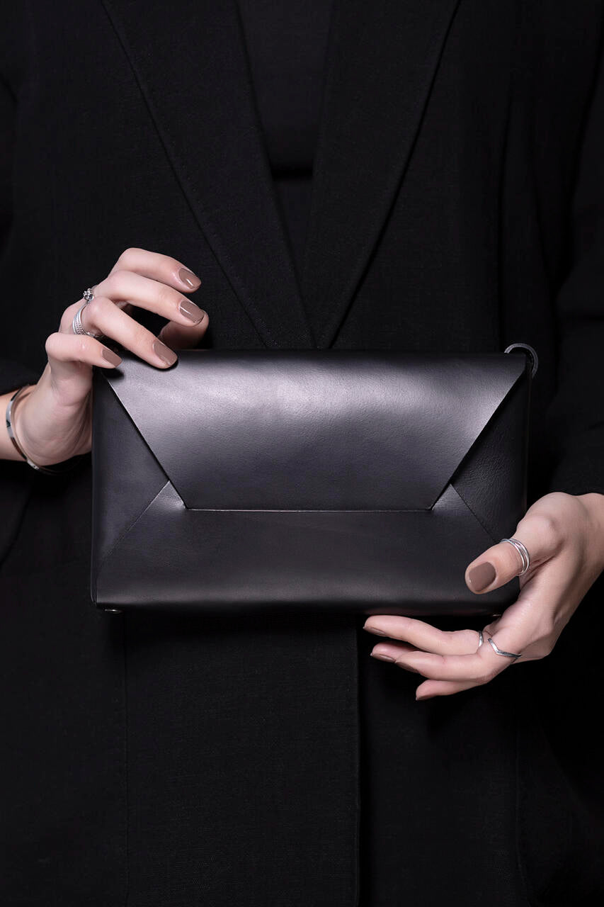 Black leather Wine & Dine evening bag by Stella Soomlais, available on USMIH Grid. Pay online with cards, Bitcoin, or altcoins.