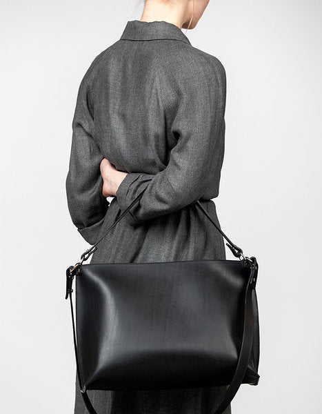 Sleek leather shoulder bag from Stella Soomlais, adjustable strap, modern style, available on USMIH Grid with crypto payment options.