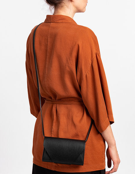 Leather clutch-wallet worn crossbody, versatile straps for clutch or handbag use, modern European design, available on USMIH Grid | Join the Grid!