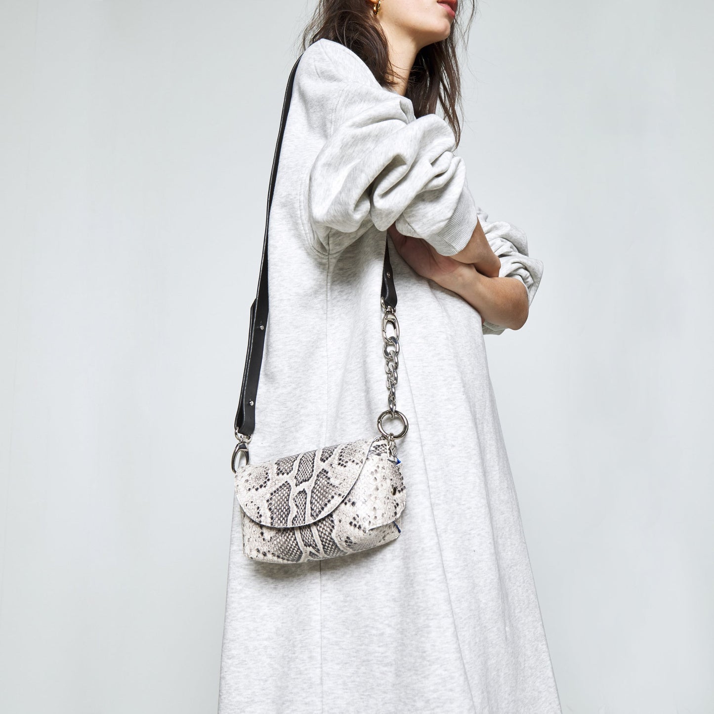 Woman wearing Handmade Leather Shoulder Bag in Snake Print, available on USMIH Grid, a popular European marketplace, Bitcoin payments accepted.