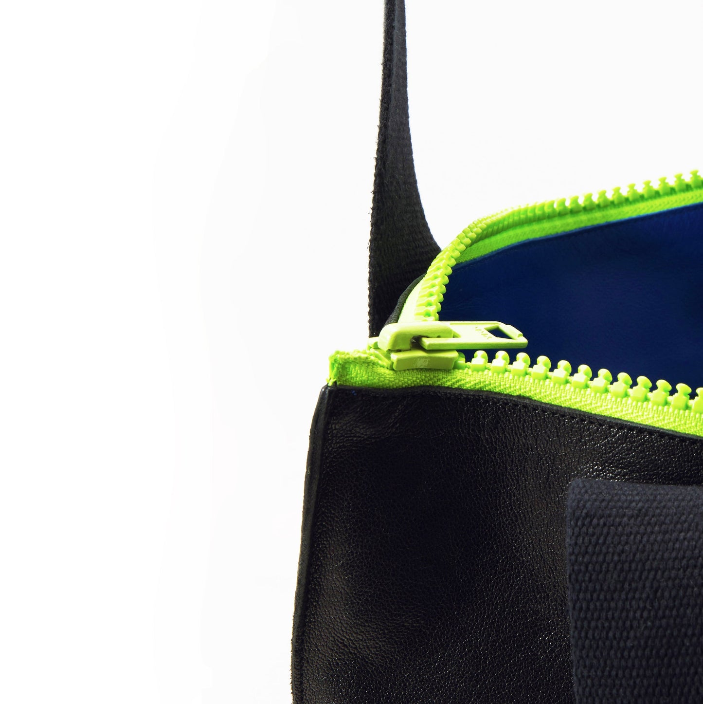 Close-up of handmade leather tote with neon green zipper from USMIH Grid, available with card and Bitcoin payments. Durable and stylish design.