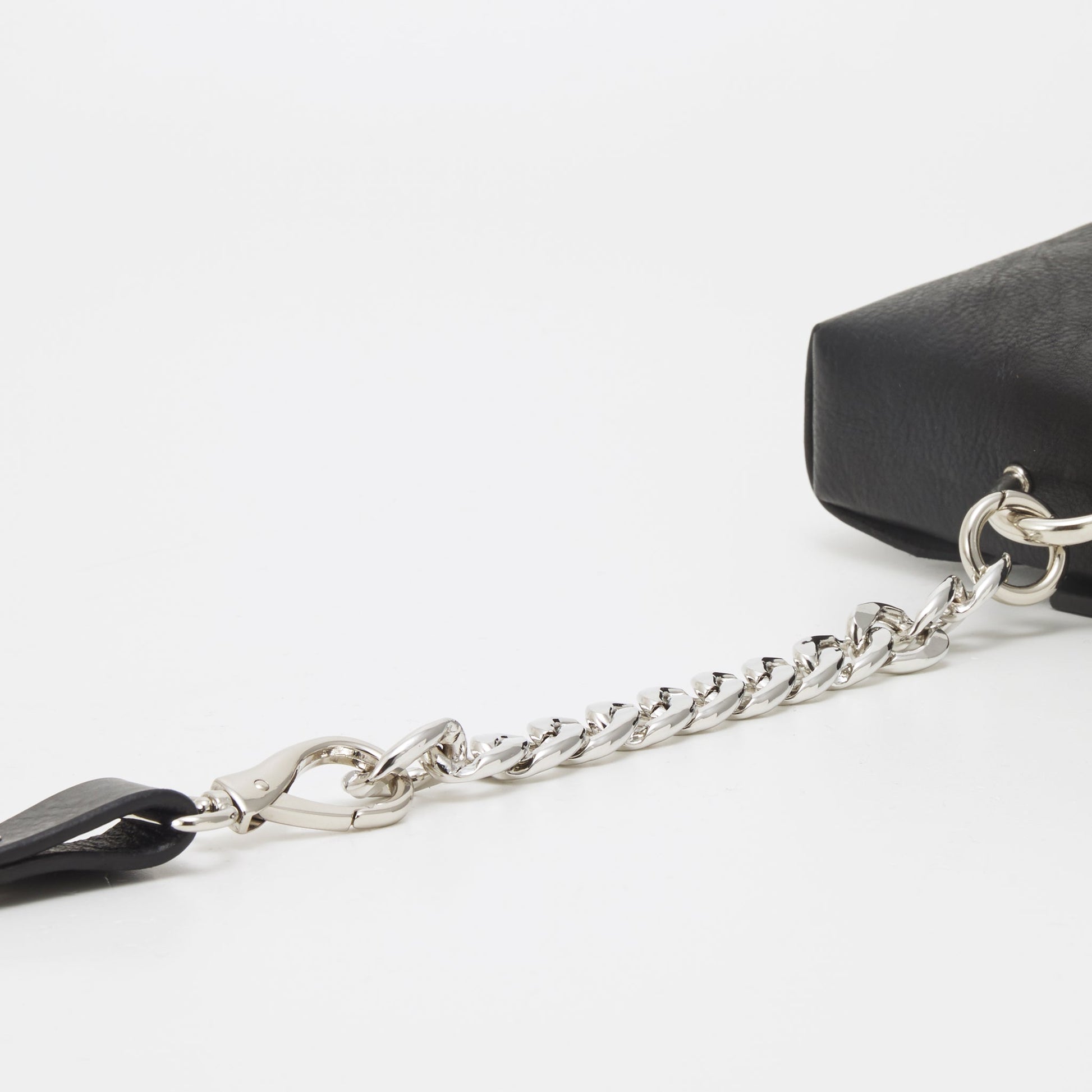 Close-up of black leather envelope bag with silver chain strap, available on USMIH Grid. Purchase with card, Bitcoin, or altcoin payments.