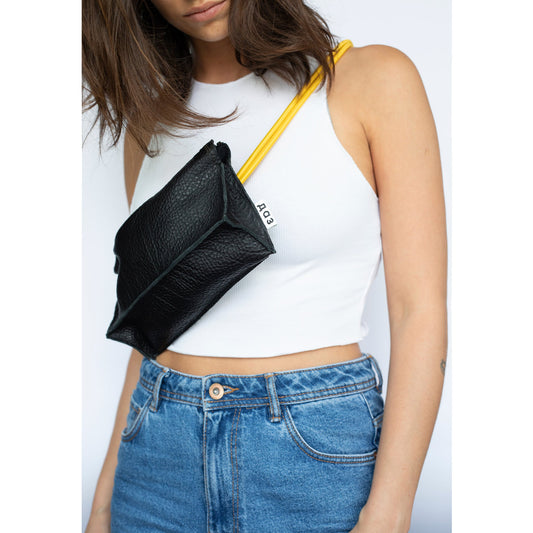 Handmade leather bum bag in black and yellow on woman, available on USMIH Grid, accepts card and crypto payments. Modern European brand.